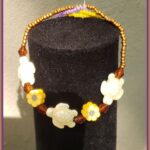 Sea turtle stretch bracelet with white turtle beads, yellow flowers and amber crystal accents on elastic cord